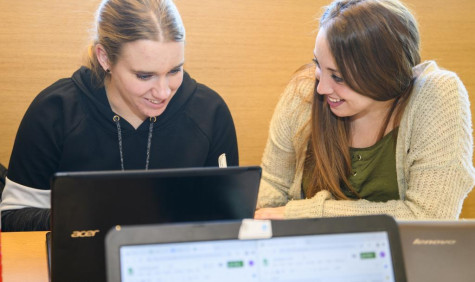 Studenten bekijken mail achter laptop