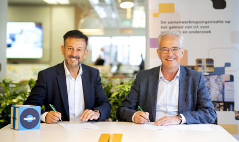Mohamed El Haddouchi, Managing Director at Nomios Netherlands and Hans Louwhoff, COO at SURF, sign the contract