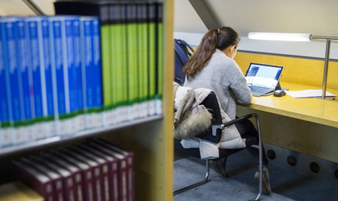 Student works on laptop in library