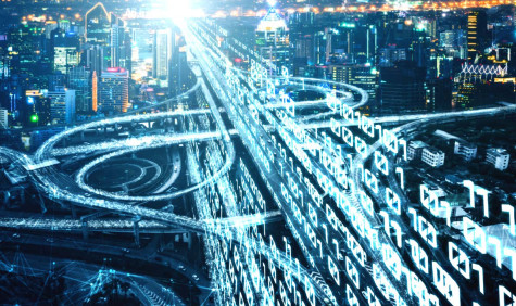 futuristic image of city with code projected over it