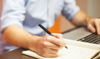 Man met pen en papier en laptop