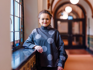 Alexandra van Huffelen stands in the corridor of Radboud University's Berchmanium monastery