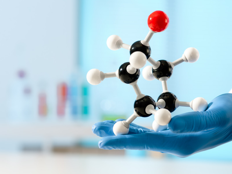 hand of scientist holds a molecular model at the lab 